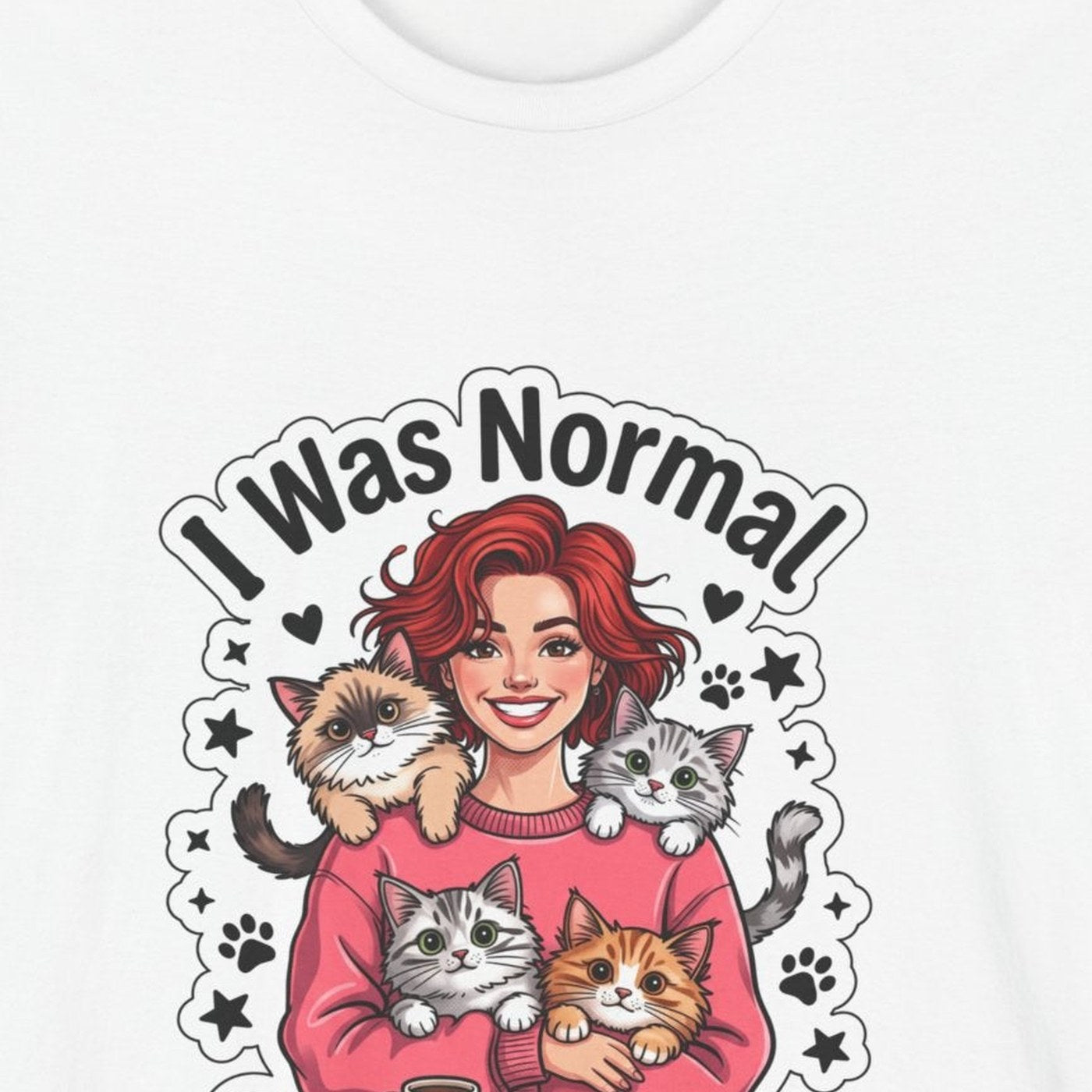 Close-up of the I Was Normal 3 Cats Ago print: red-haired woman in a pink sweater holding three cats, on the White tee