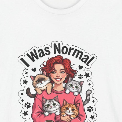 Close-up of the I Was Normal 3 Cats Ago print: red-haired woman in a pink sweater holding three cats, on the White tee